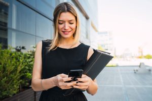 Business woman accessing mobile communications